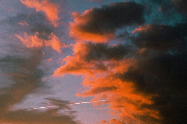 the view is taken from a boat looking toward a bright blue sky and red clouds