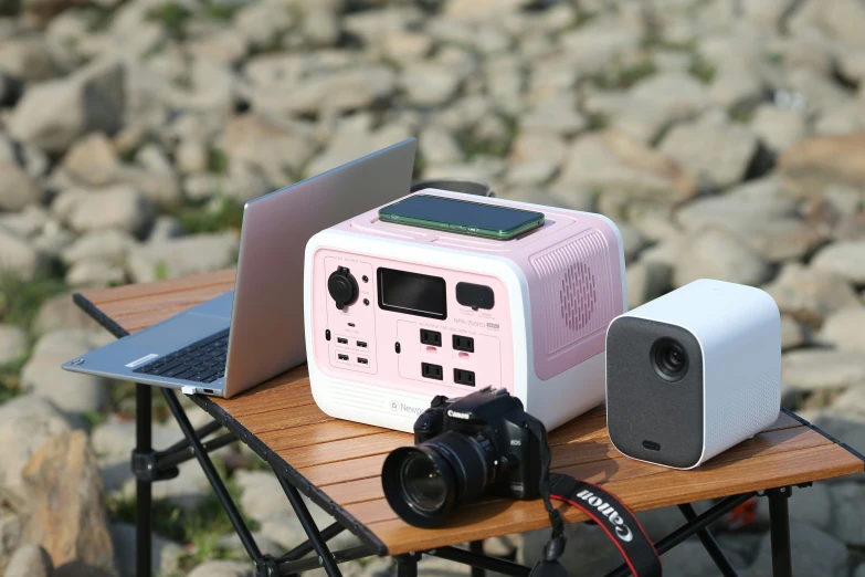 some electronics are placed on a table near rocks