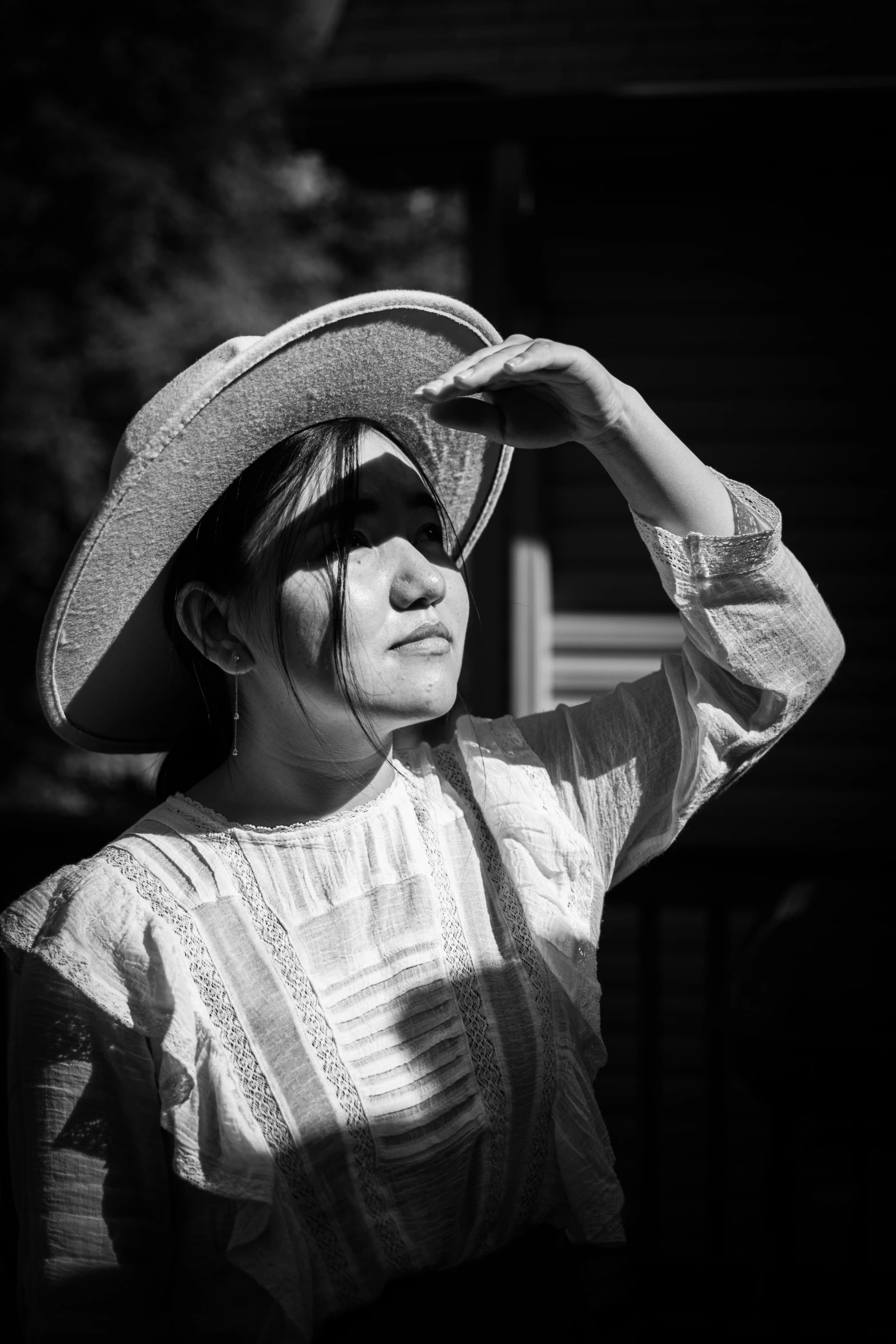 black and white picture of a woman wearing a large hat