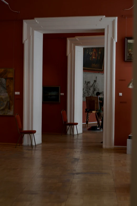 red and white rooms with chairs inside a building