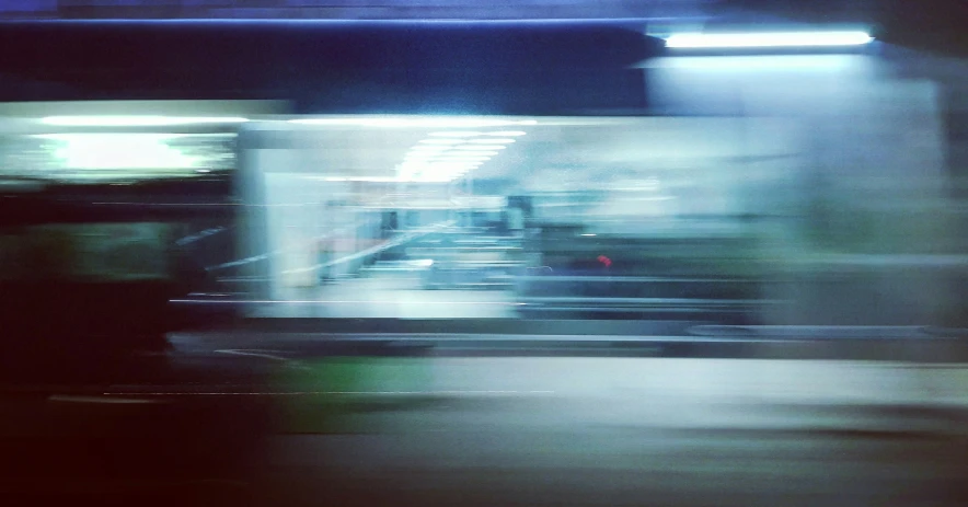 a blurred image of a street lights, street lamps and cars in motion