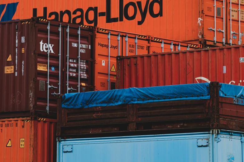 an overhead bunk bed in front of shipping containers