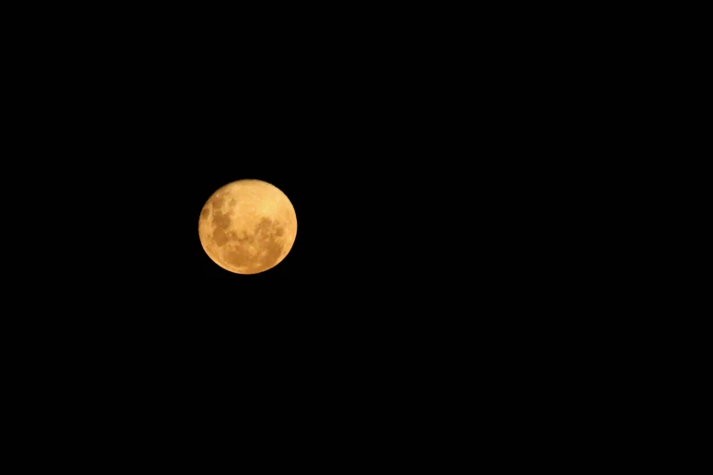 the full moon is shown from inside of the sky