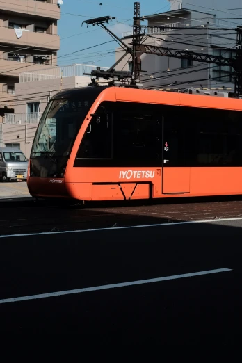 an orange street car parked on the side of a road