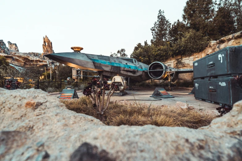 a plane parked on top of a sandy field