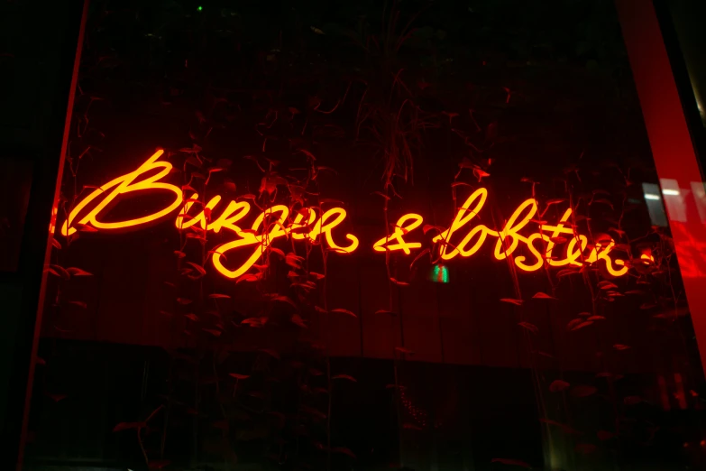 neon sign lit up in red with black background