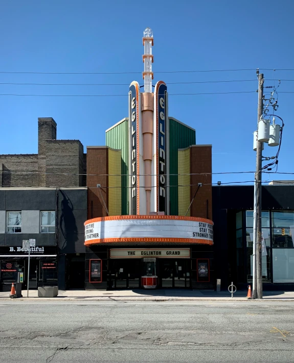 a theater and building are next to each other on the street