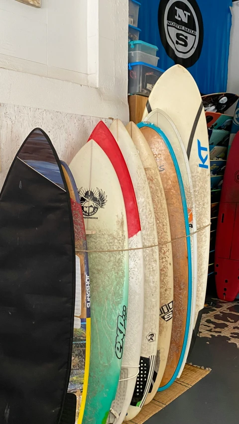a number of surfboards behind a fence in a store