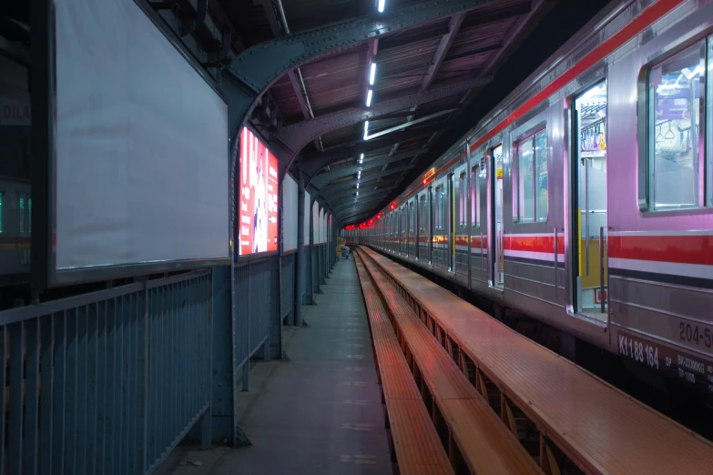 the train in the subway station is red and white