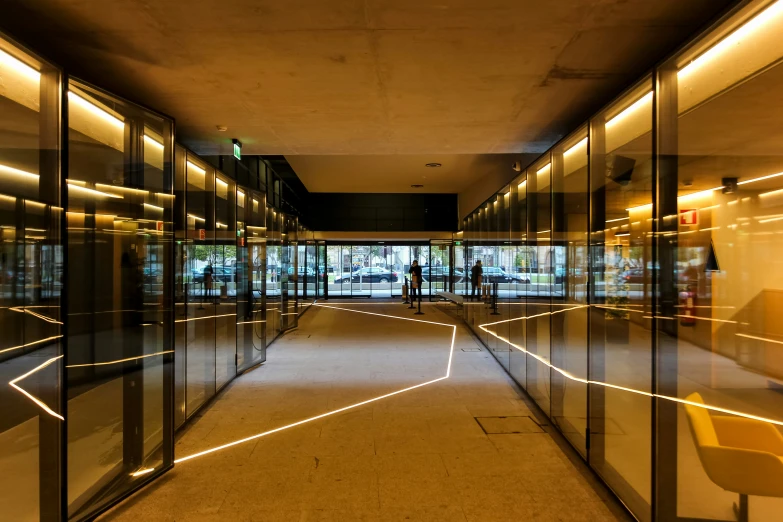 a large hallway lined with glass walls and chairs