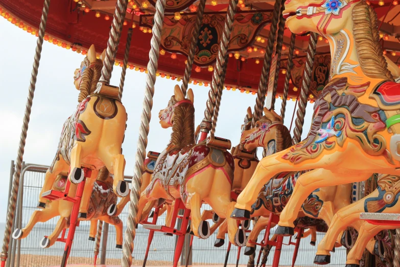 several large merry go round horse on a carnival carousel