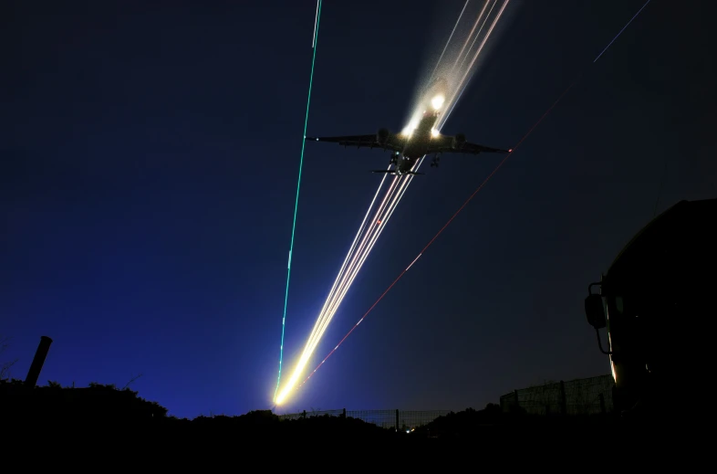 an airplane flying through the night sky