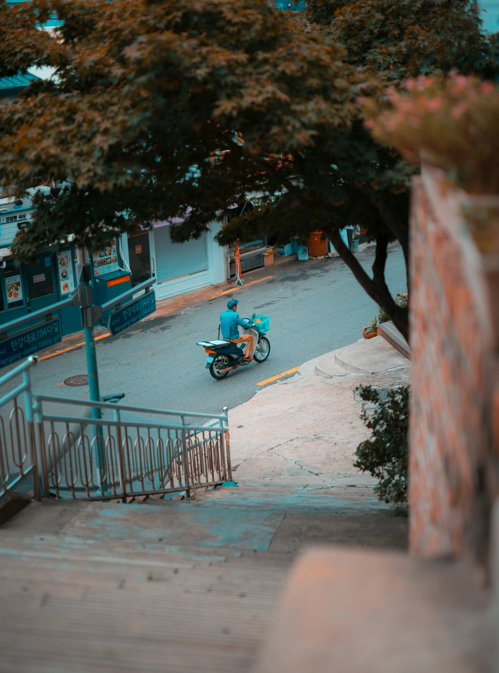 a guy on a motorcycle and another person on the street