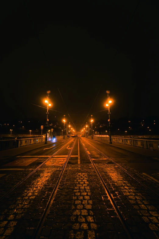 street lights shine brightly at night on a track