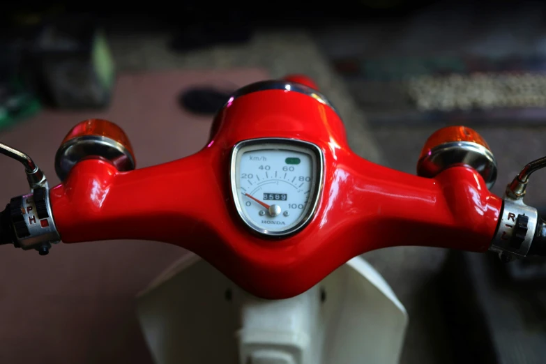 a red clock mounted to the back of a white bike