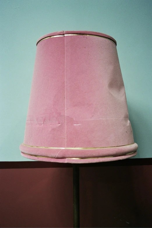 a lamp sits on a stand with its cover up