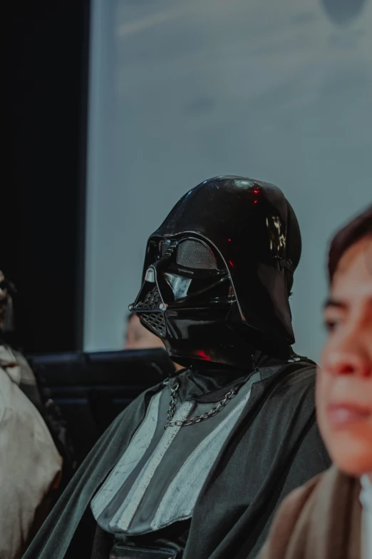 a  dressed as darth vader with a star wars helmet