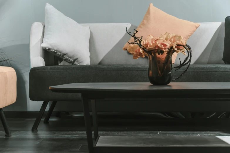 a living room with a couch, table and chair and pillows