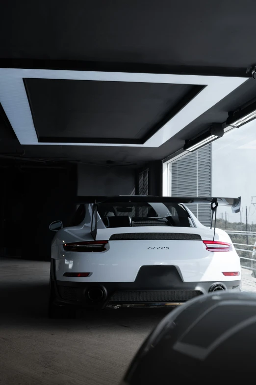porsche cars in a garage with some windows and door frames