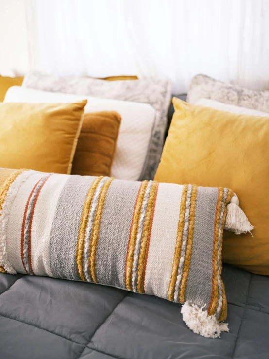 a bed with colorful pillows sitting in the middle of it