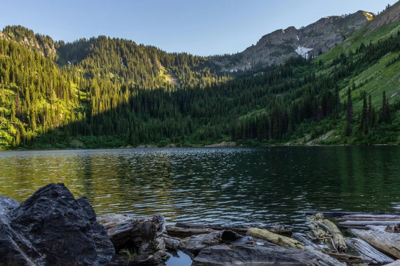 a small mountain lake with some rocks and water