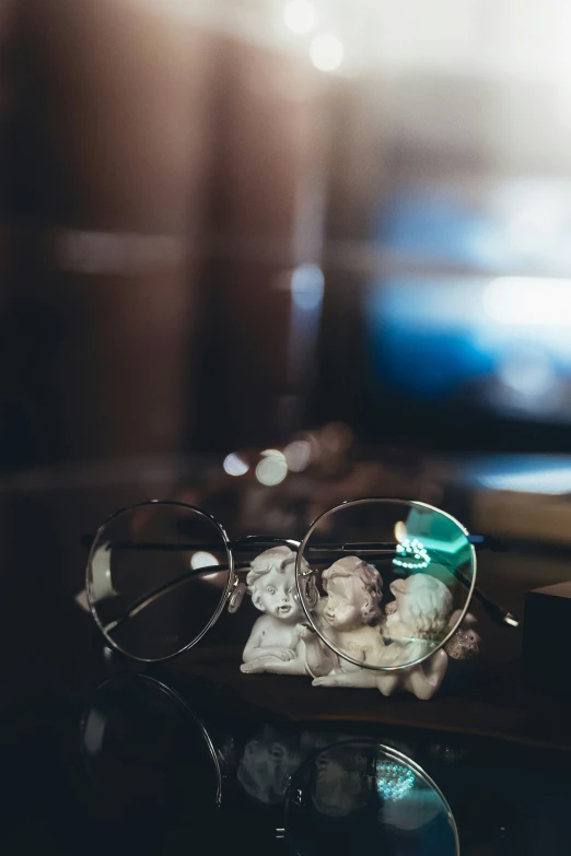 a pair of glasses sitting on top of a table