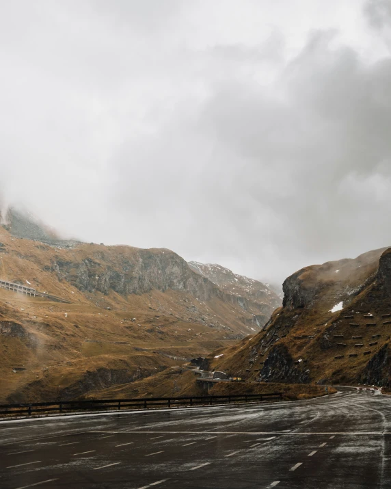 a mountain view in the middle of nowhere with clouds in it