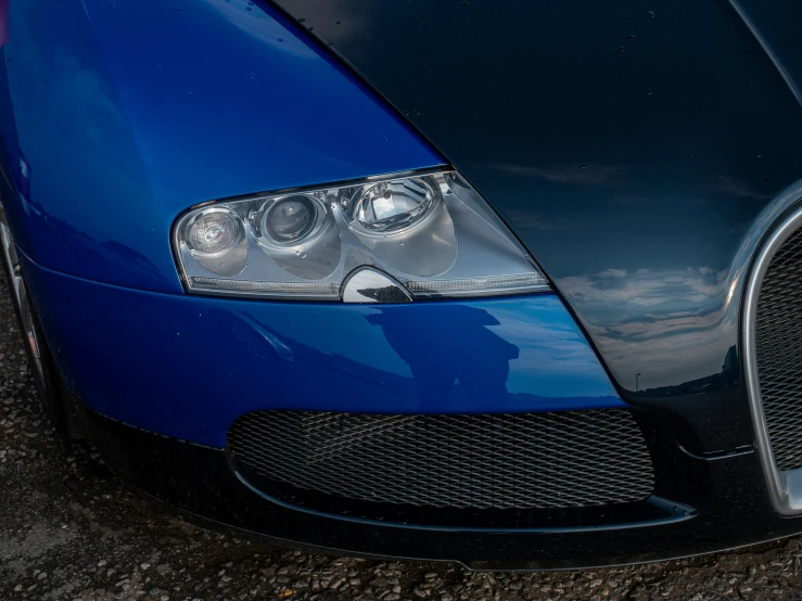 the front end of a blue sports car