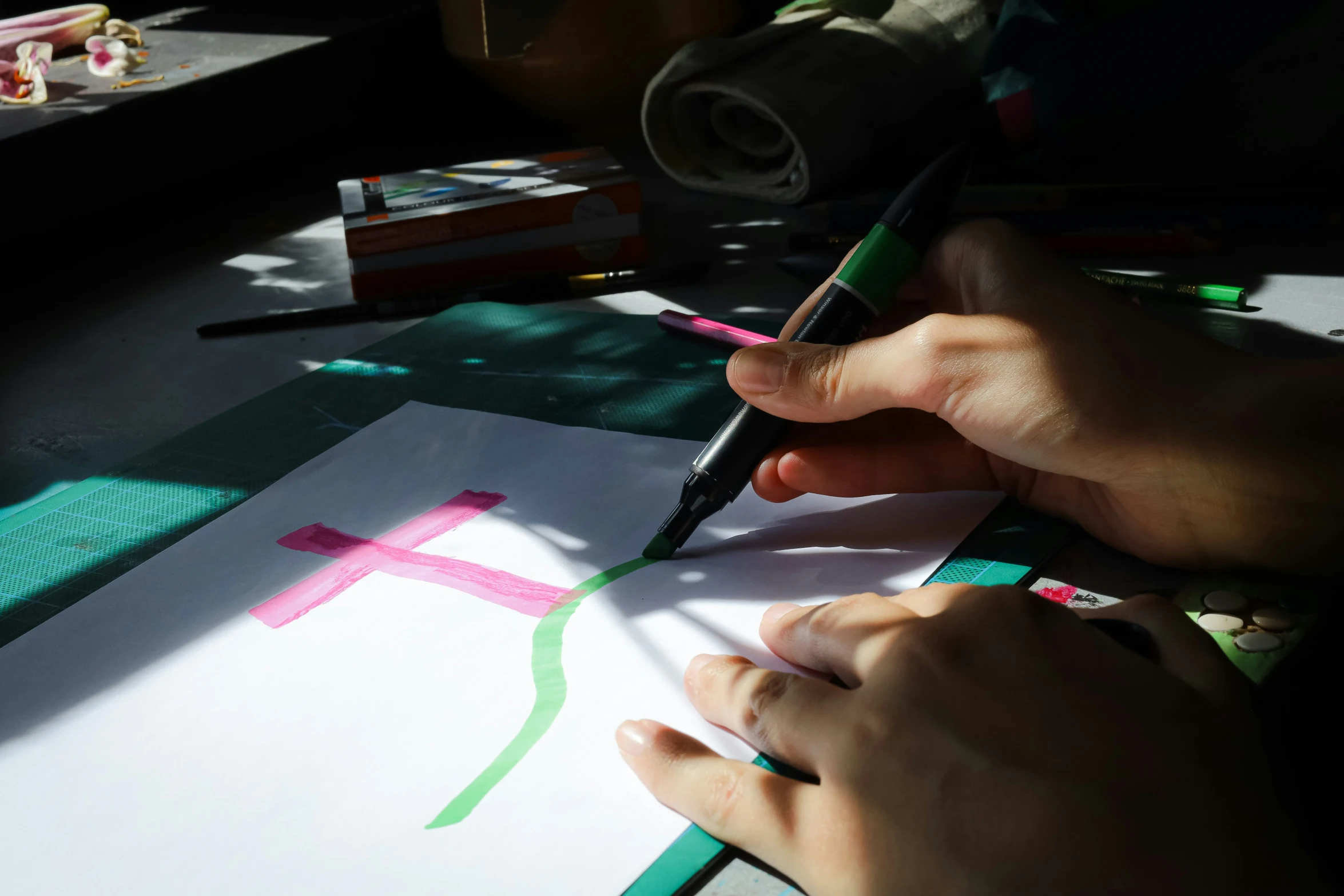 woman working on her art project with markers and colored paper