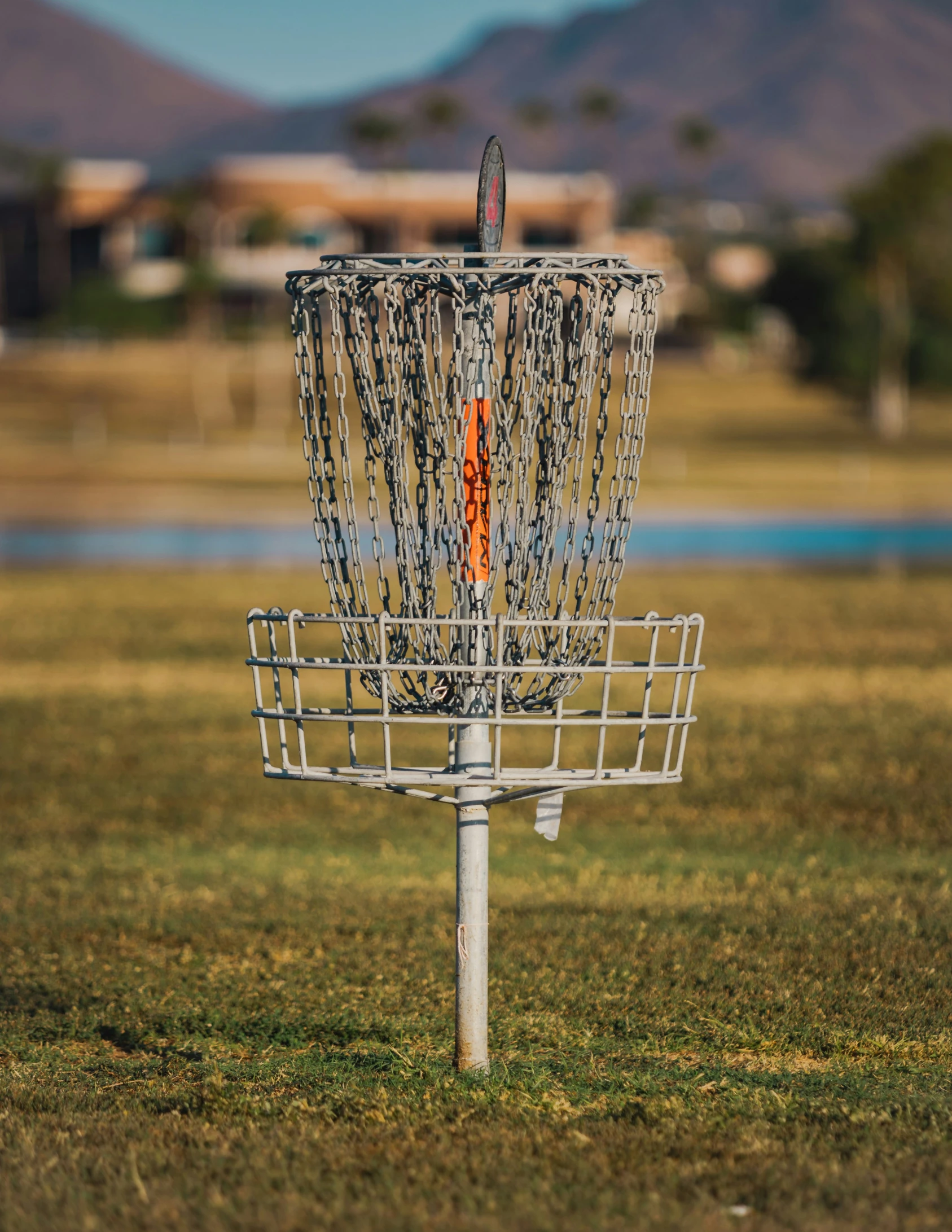 a white frisbee golf cage in grass