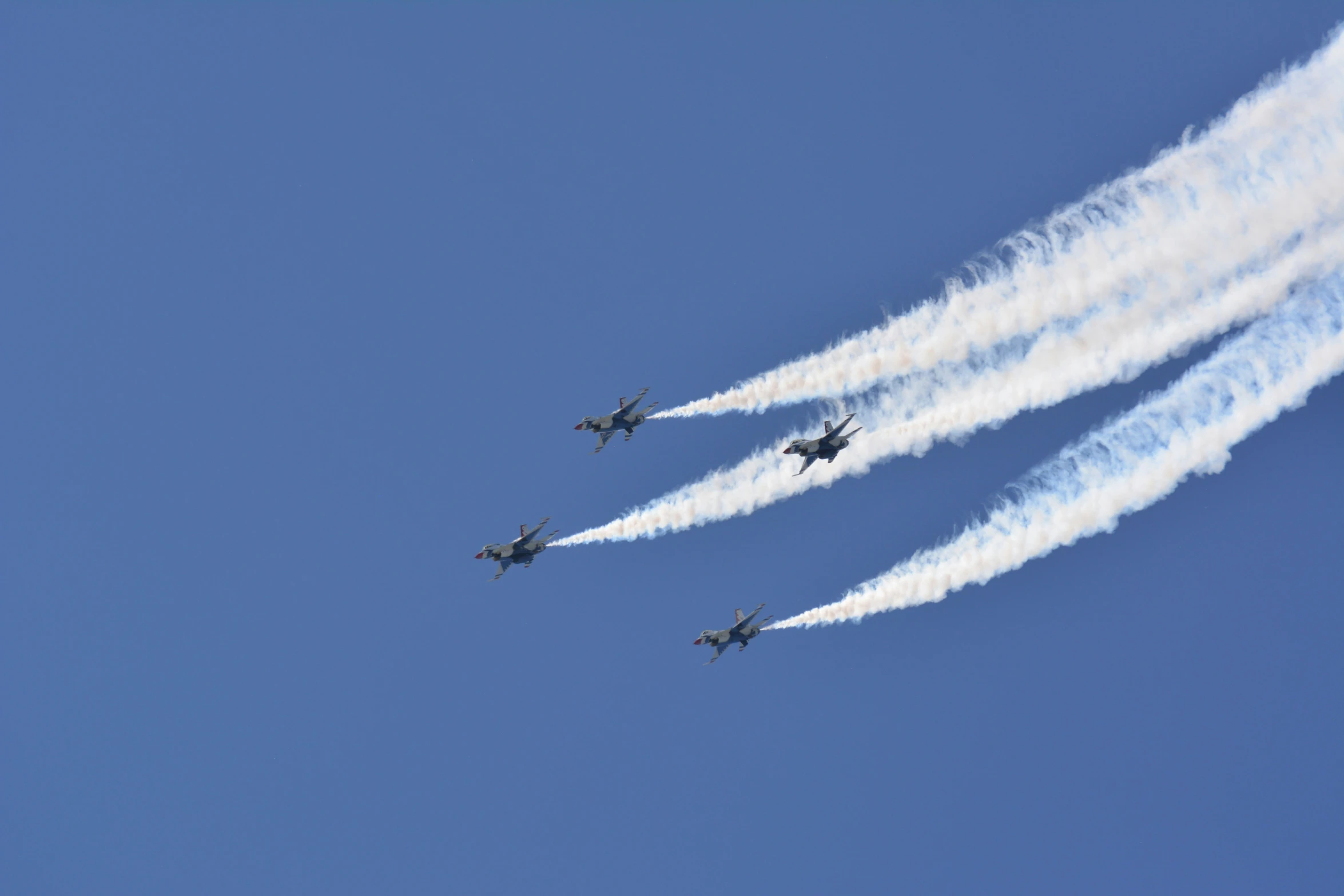 the four planes are flying together in the sky