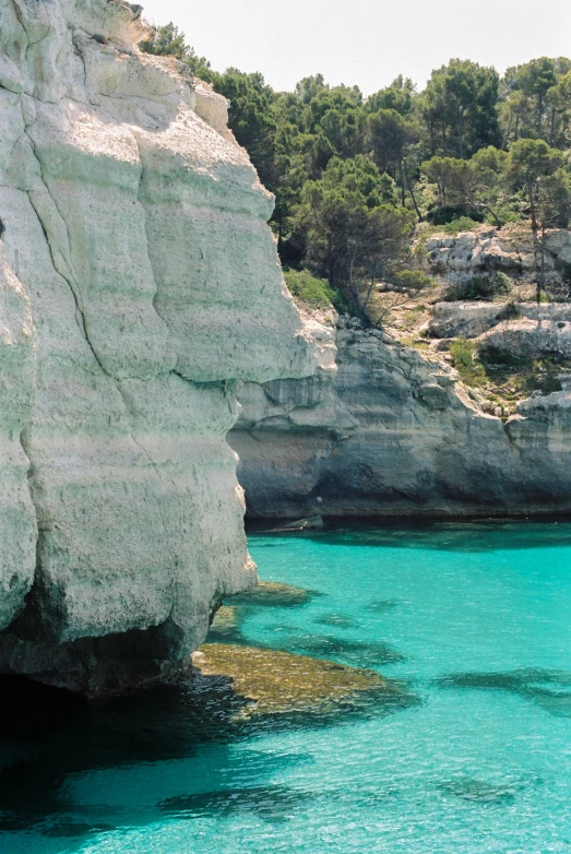 the turquoise blue water in an open cliff pool