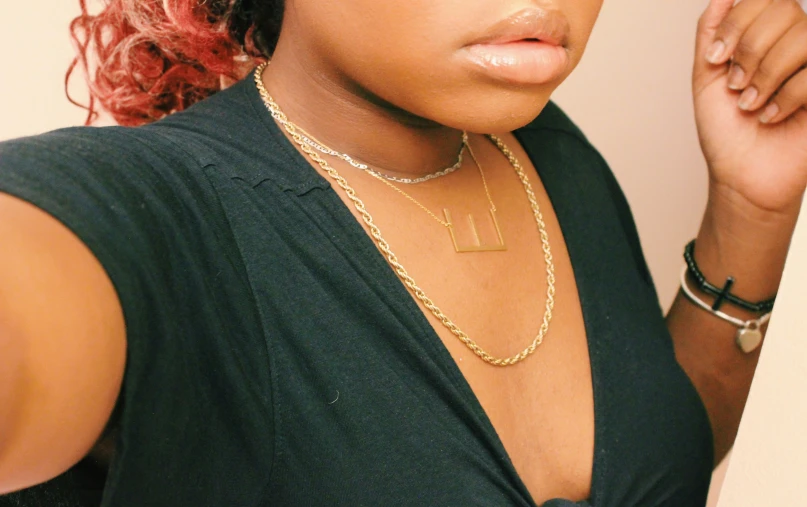 a young woman is staring straight ahead wearing a choker