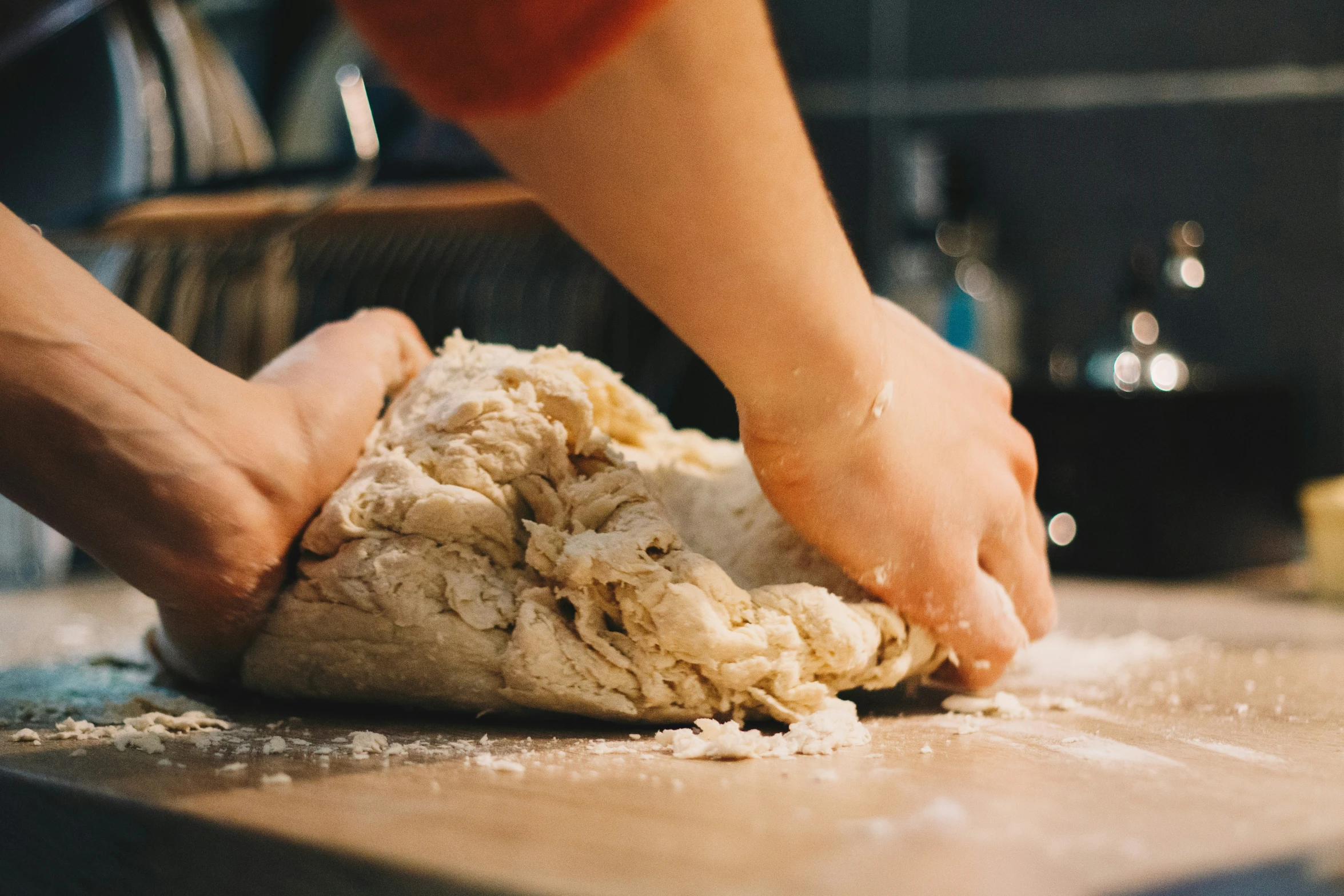 a person putting some dough on top of the counter