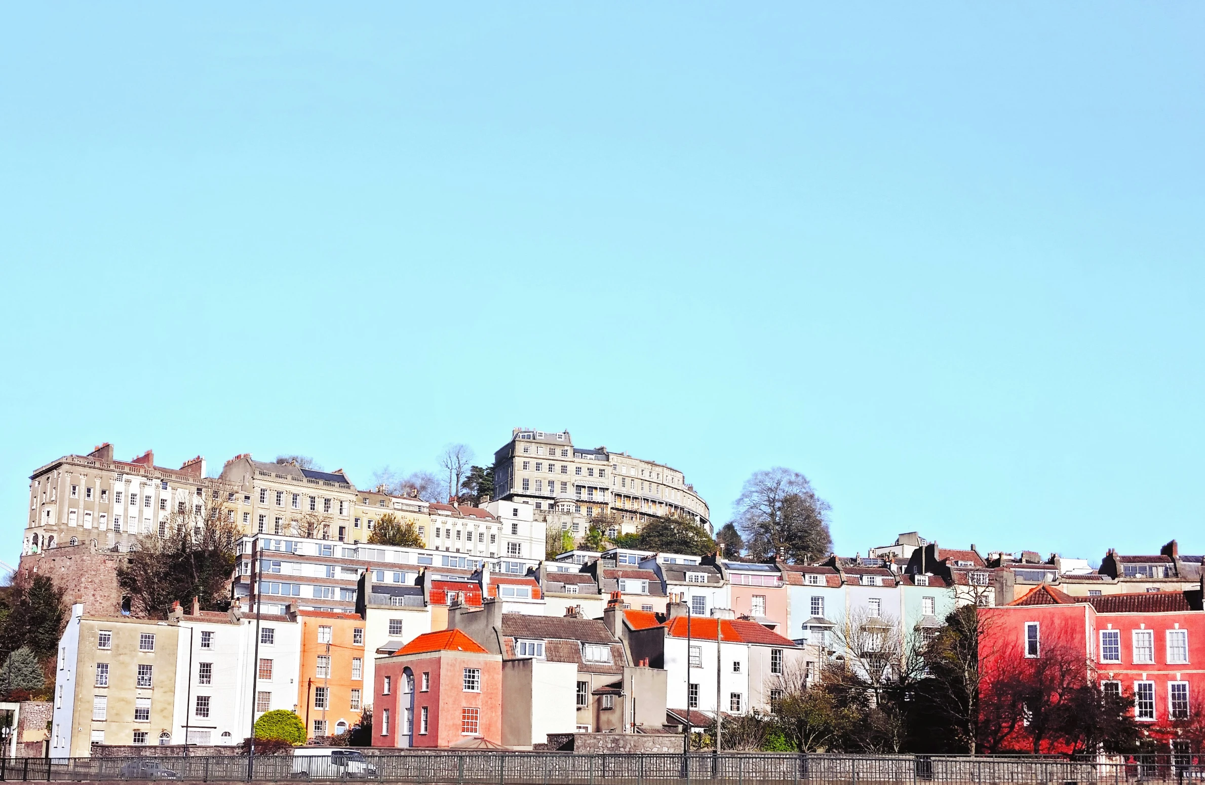 a townscape with buildings on the hill above it
