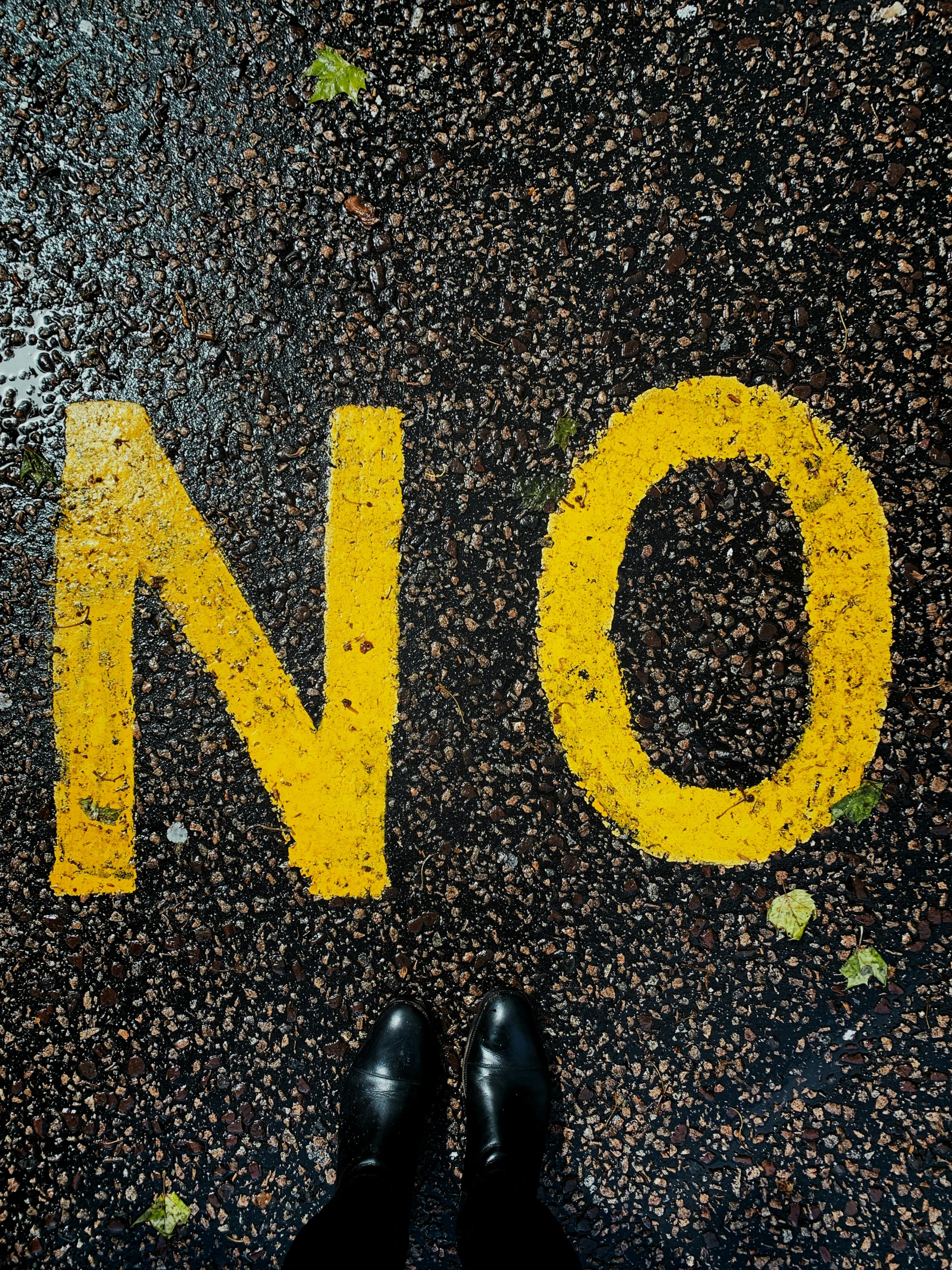 a man standing on a street and the words no written in it