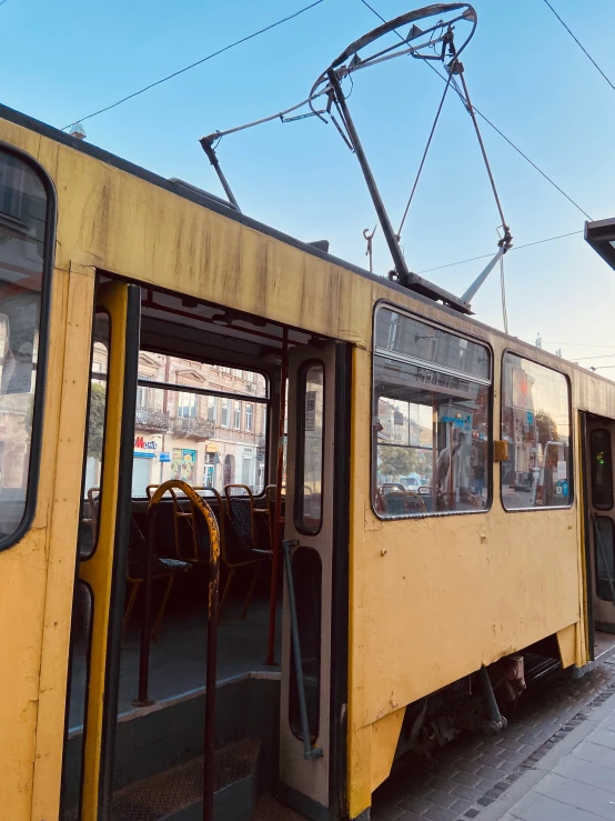 a train that has its doors open near a street