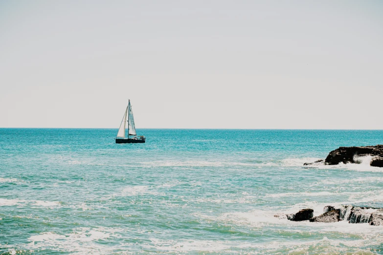 a sail boat in the open water on a sunny day