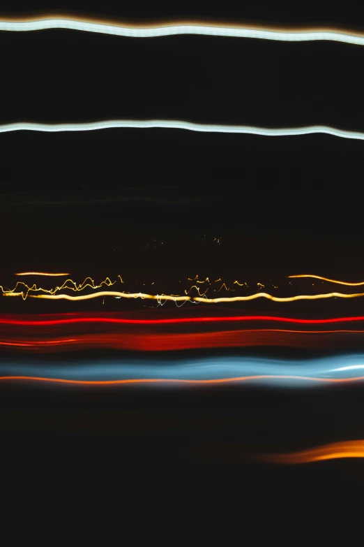 blurred pograph with light streaks over dark background