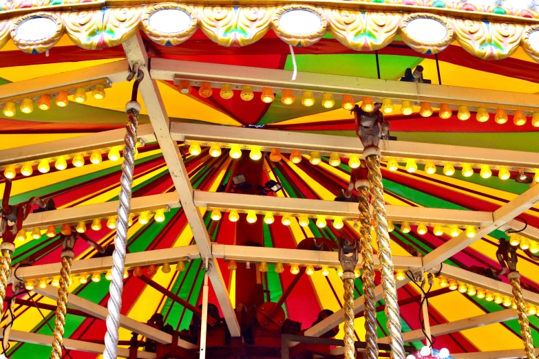 a circus swing with lights in front of a carnival tent