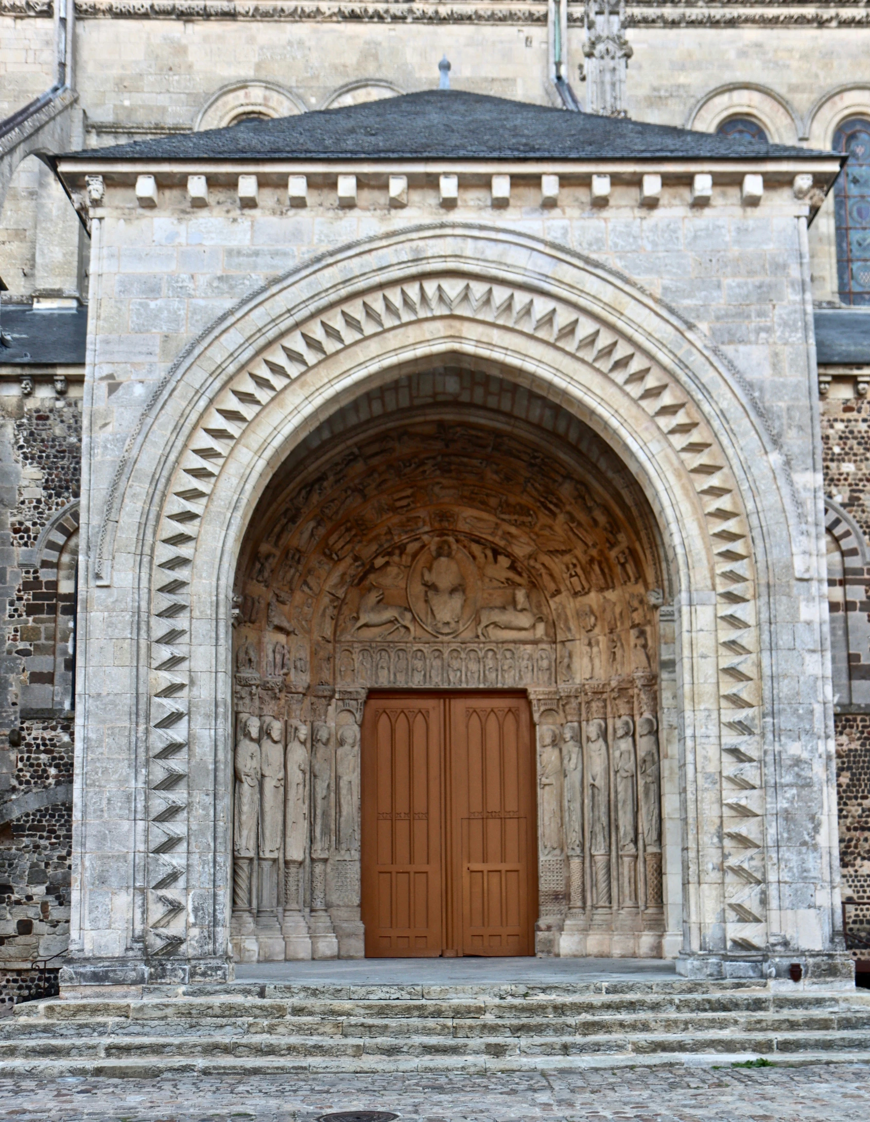 an ornate stone building with a big brown door