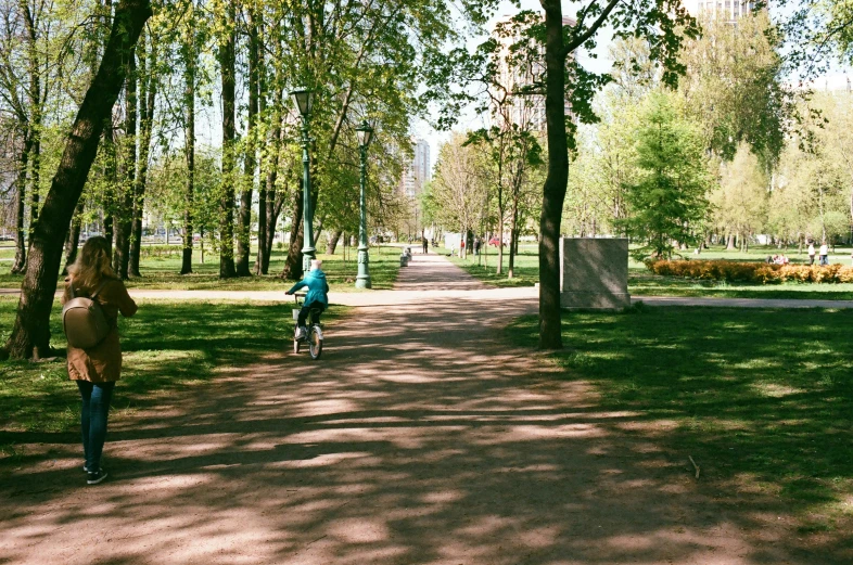 s riding their bikes in the middle of a park