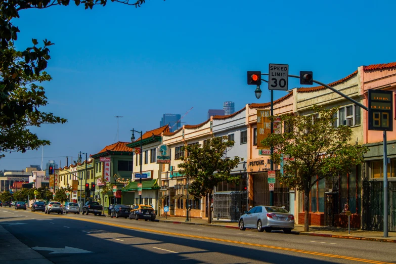 an empty street with cars parked on the sides