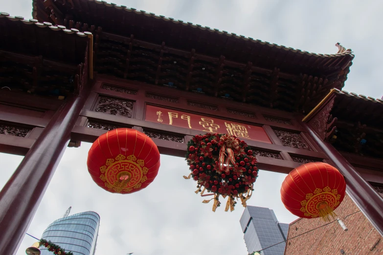 lanterns hanging above a large arch at a building