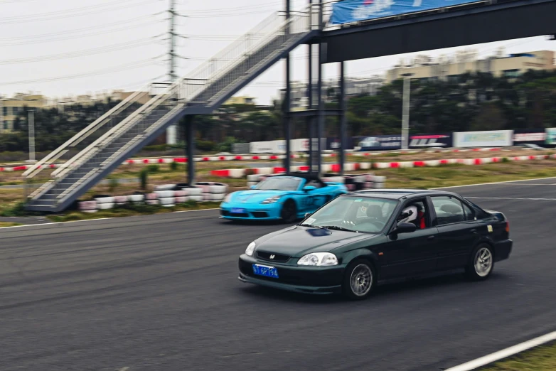 two cars driving on a race track in motion