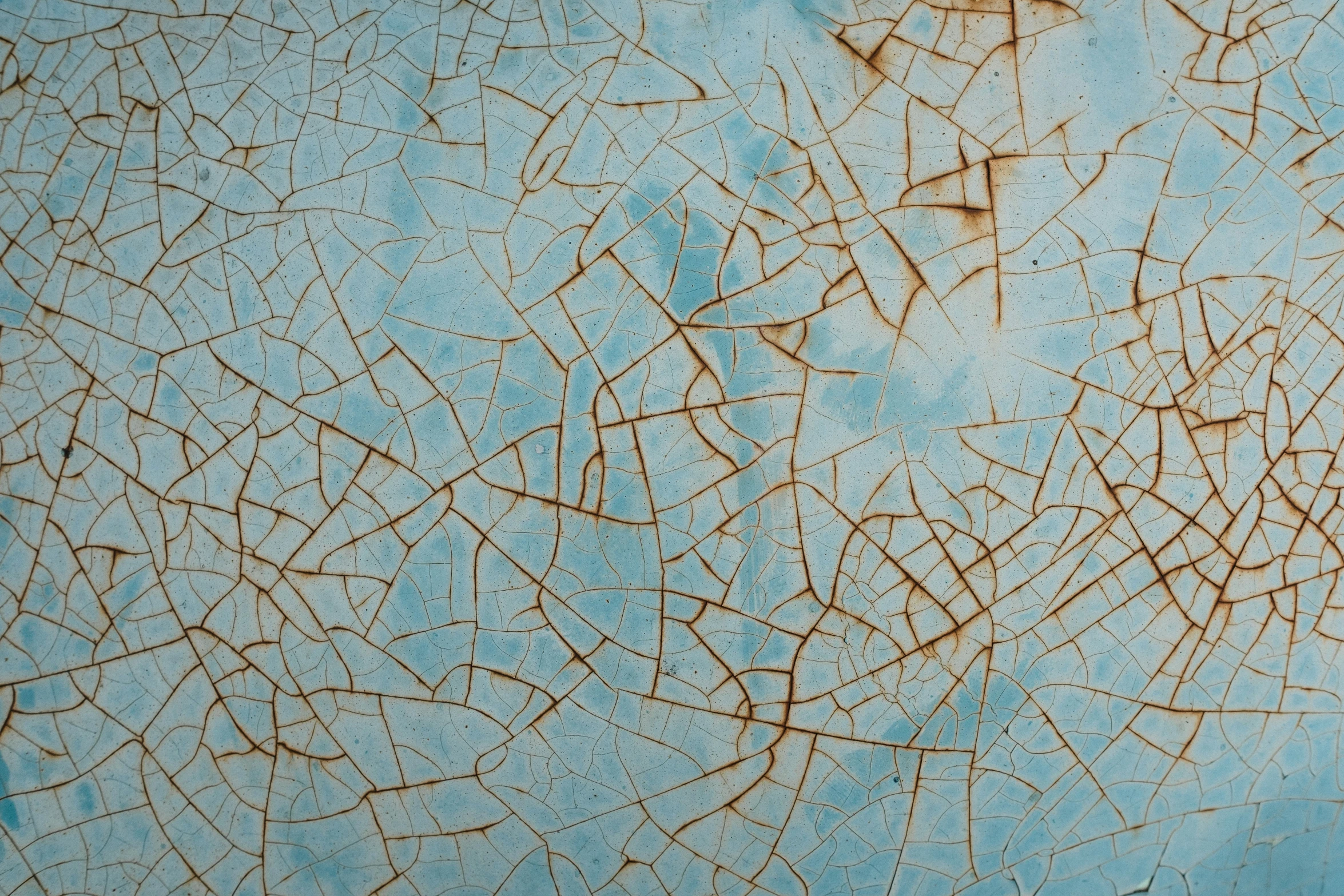 a blue metal background with rough peeling lines