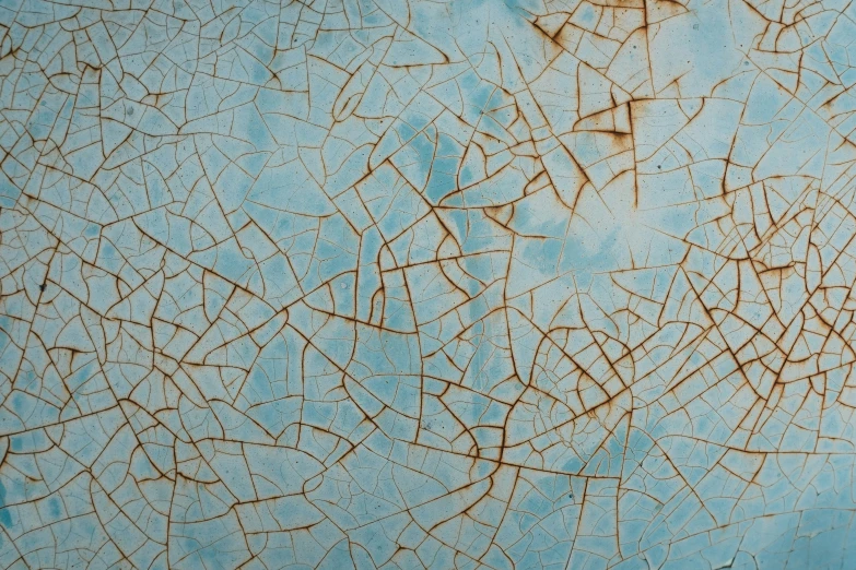 a blue metal background with rough peeling lines