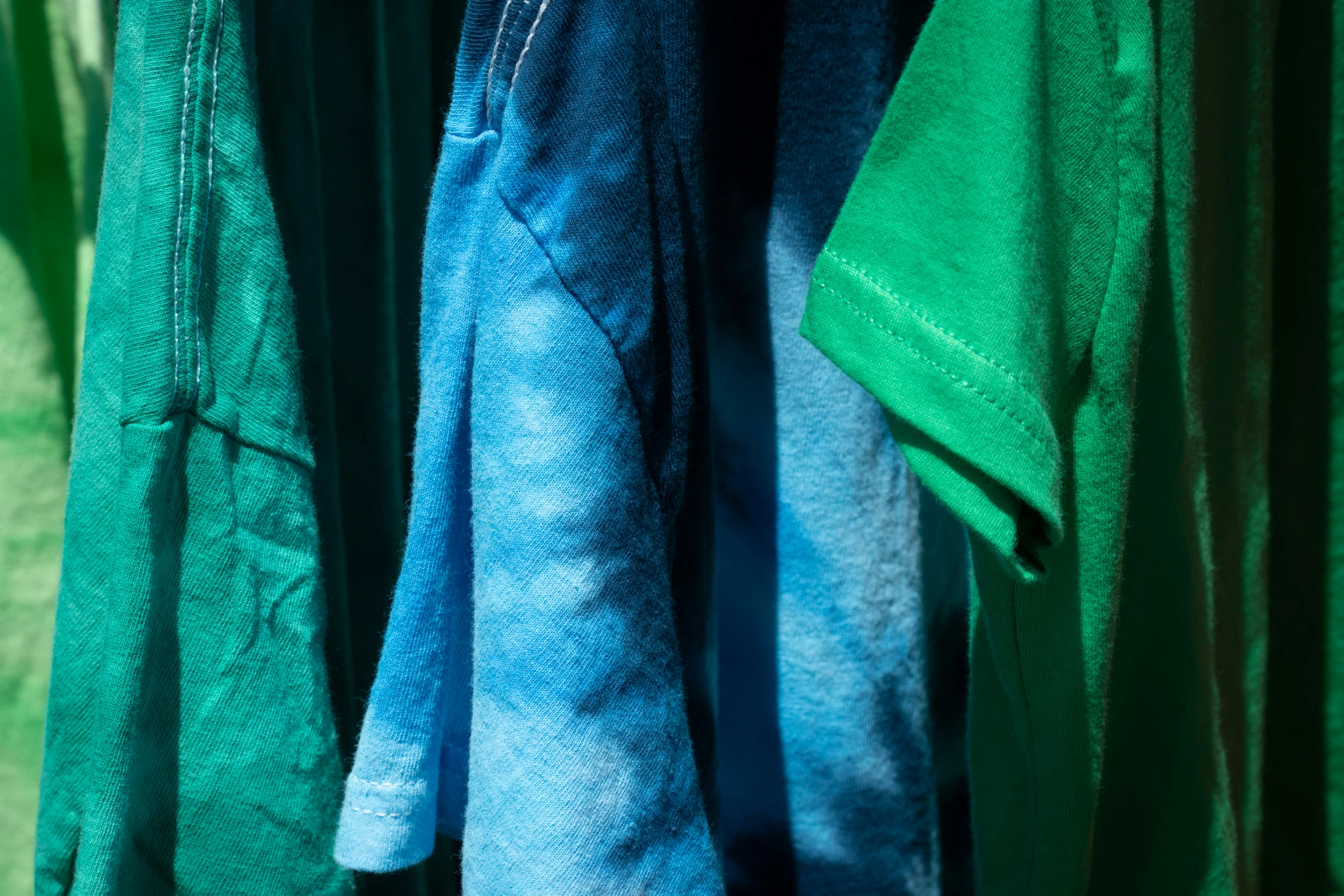 folded clothes hanging in a line outside on the ground