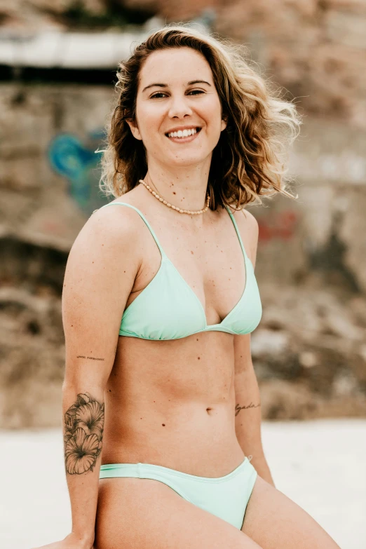 the woman in the bikini has a tattoo on her arm