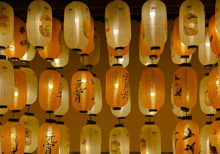 a bunch of lighted lanterns are in a building